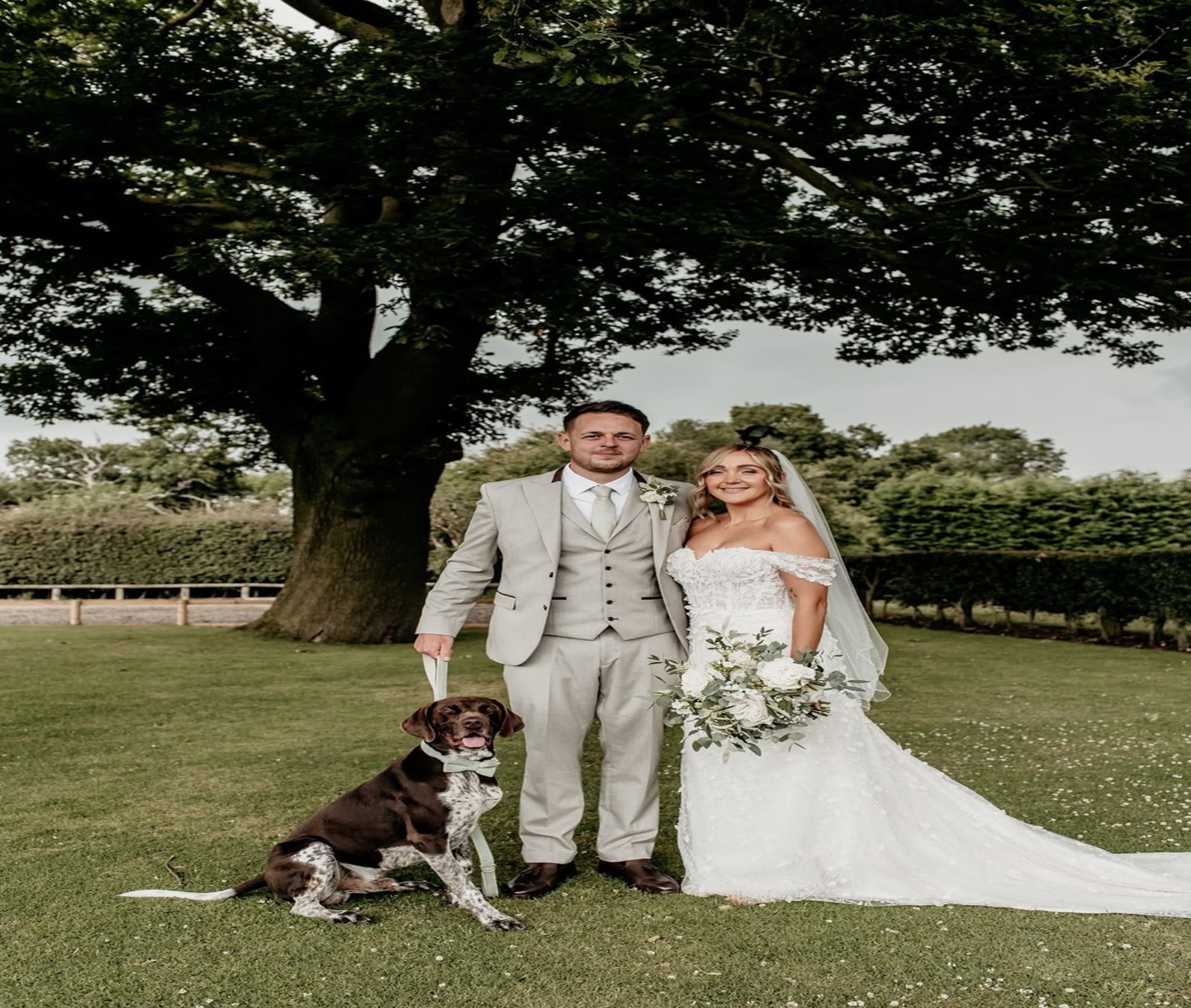 Bride and groom with their dog in the gardens at Oak Farm Hotel